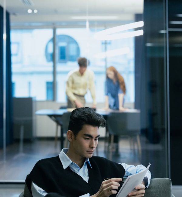 Person sitting at a desk by a window, taking a moment to breathe deeply.